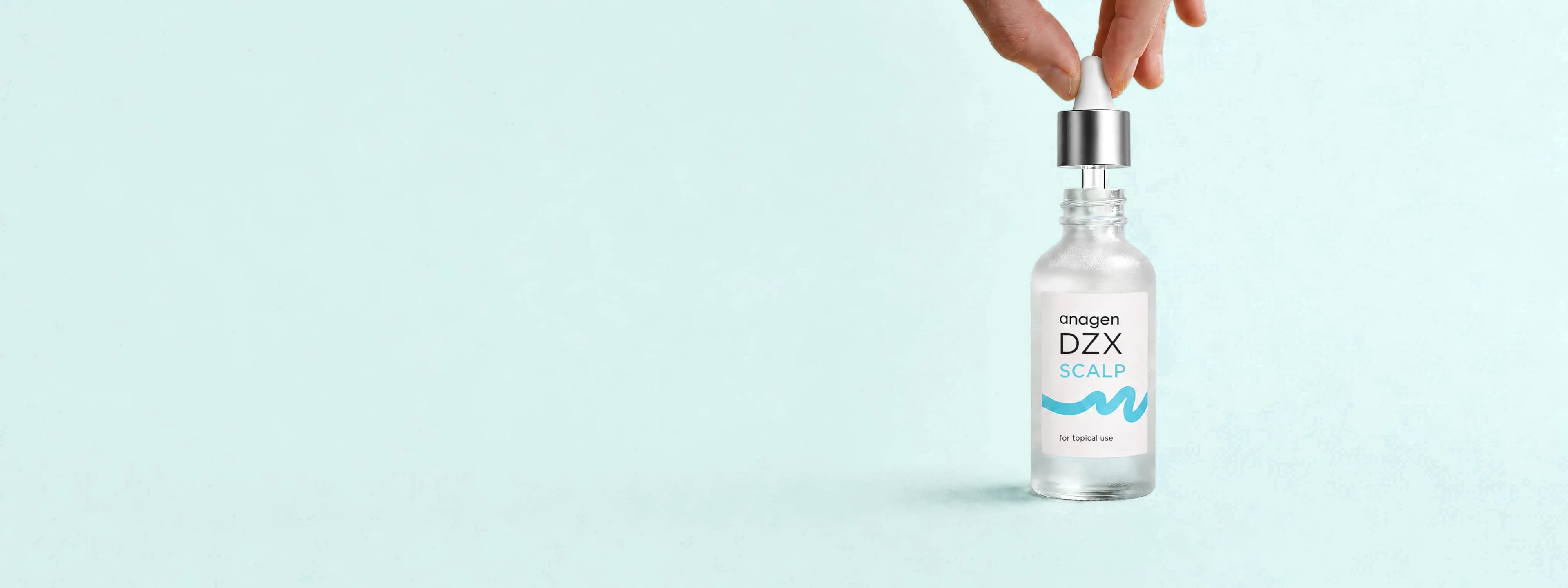A hand lifting the dropper from a bottle of anagen DZX Scalp, the investigational topical diazoxide preparation