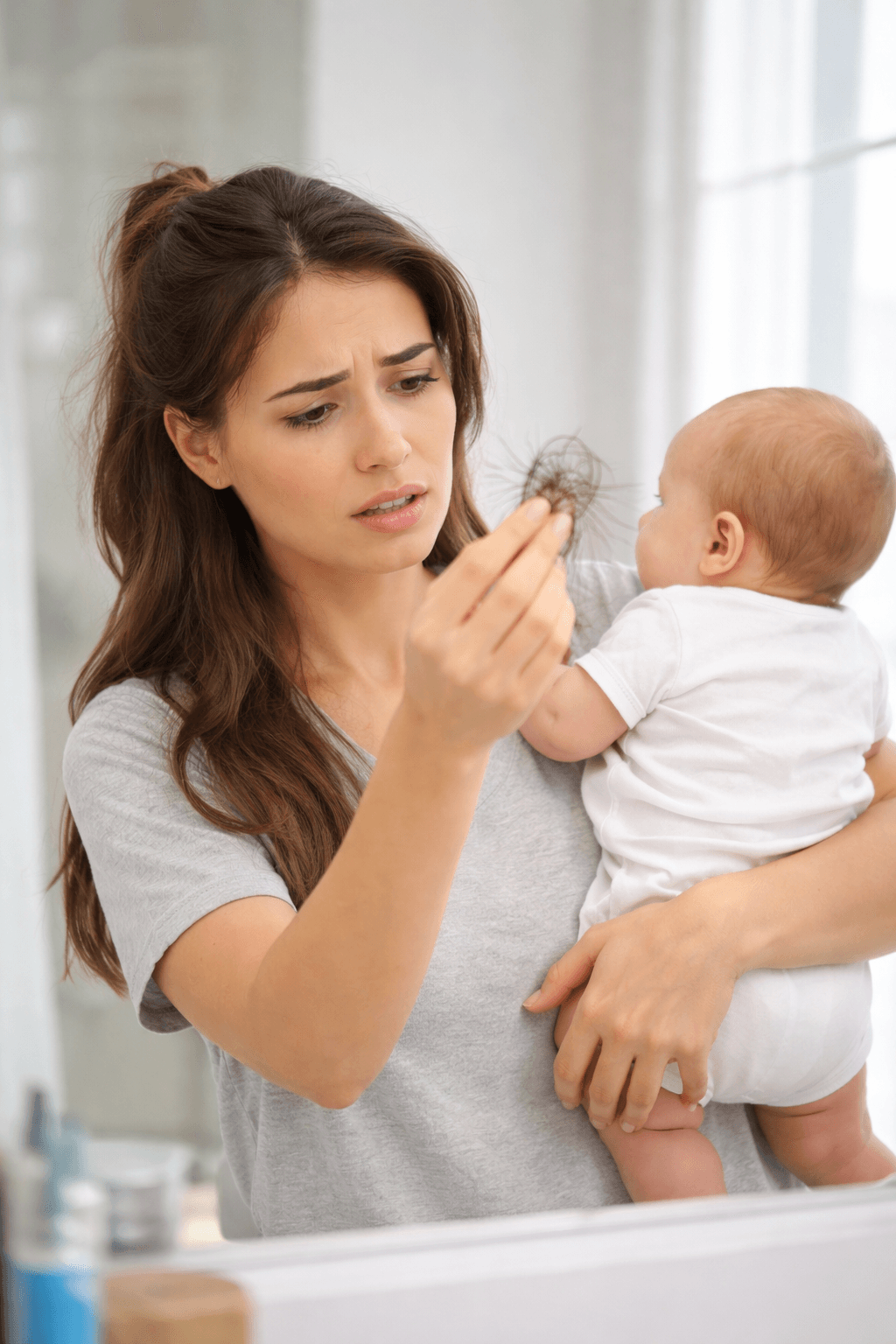 Postpartum Hair Loss: Mom Checks Hair in Mirror